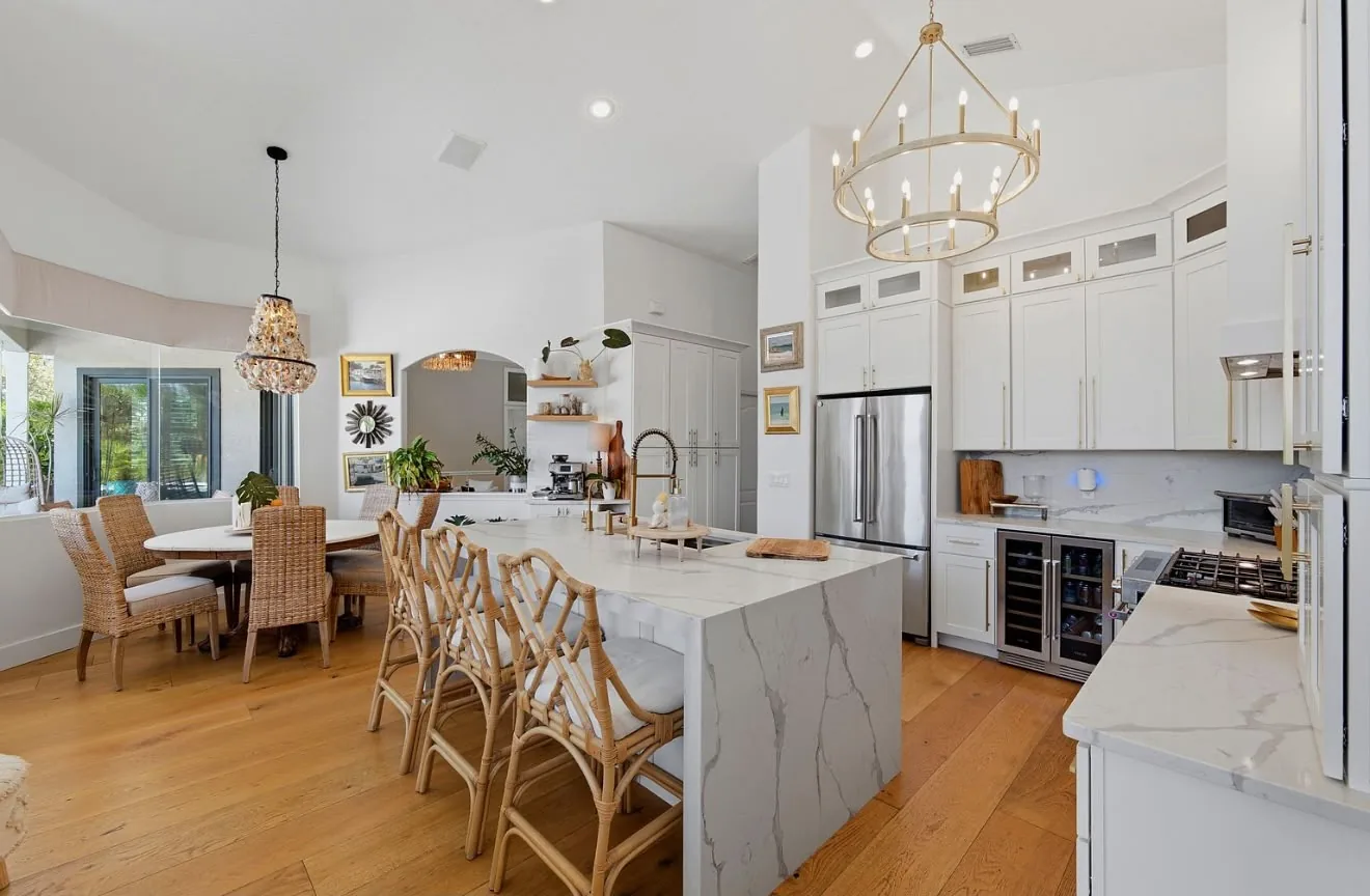 Open kitchen and dining area with rattan chairs and an oak floor